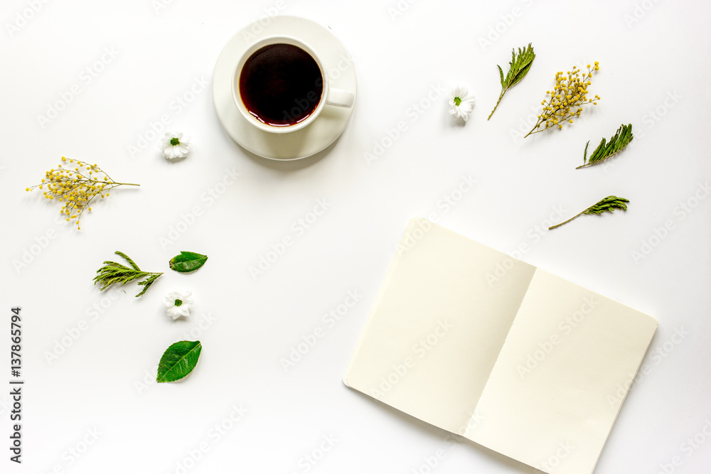 Copybook, americano and flowers on white table top view mock-up