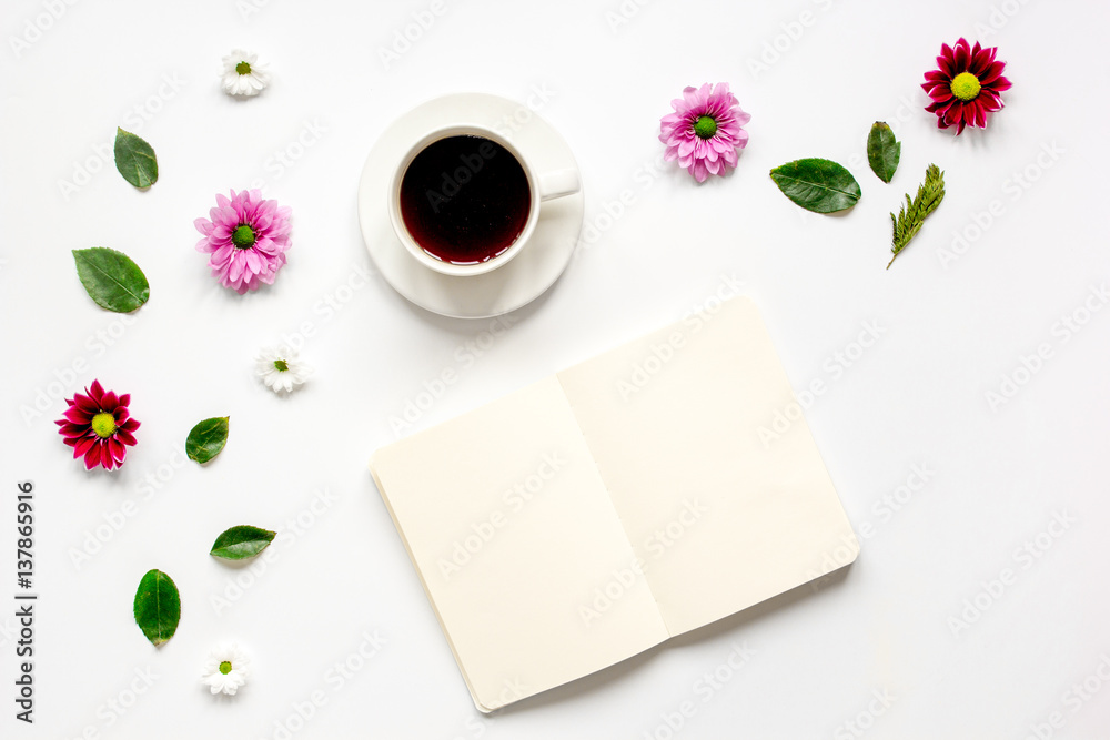 Froral flat lay with cup and notepaper top view mockup