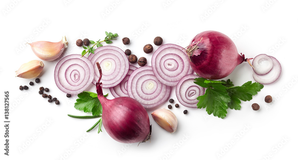 red onions, garlic and various spices on white background