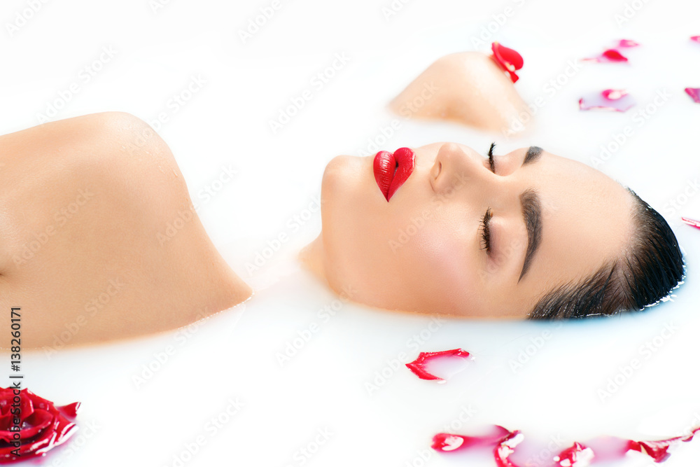 Beautiful fashion model girl taking milk bath, spa and skincare concept