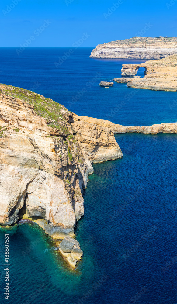 Gozo, Malta - The Fungus Rock and the Azure Window at Dwejra bay on a beautiful summer day with clea