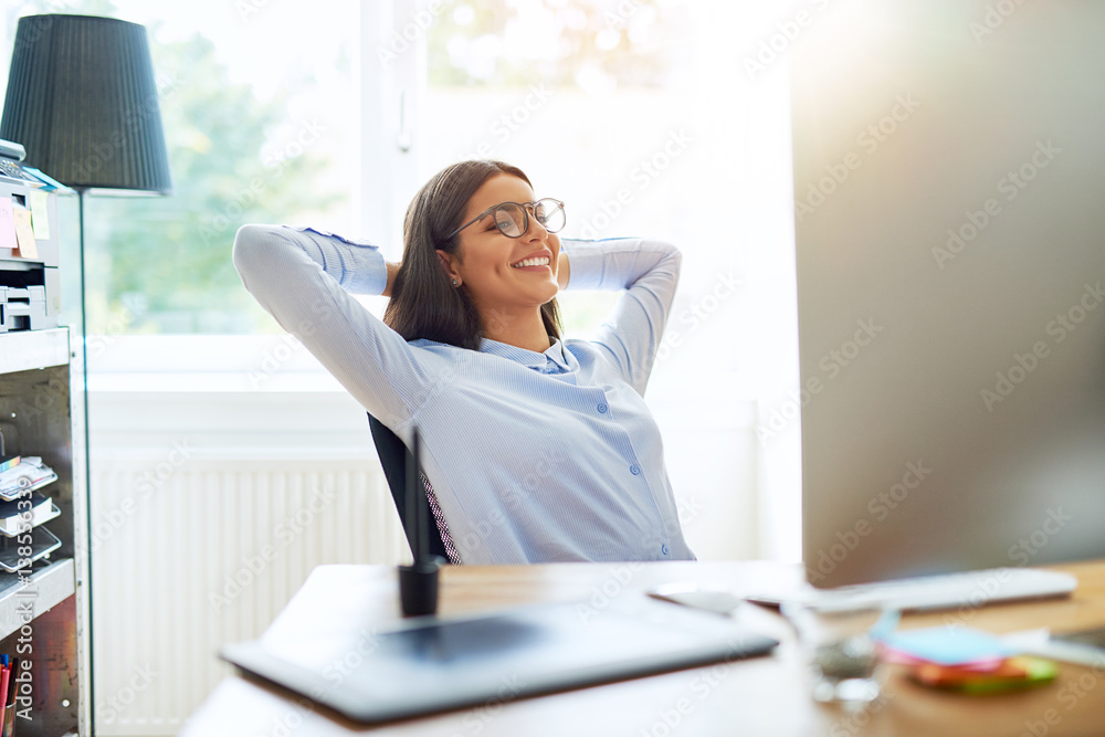 Happy woman with arms folded behind head