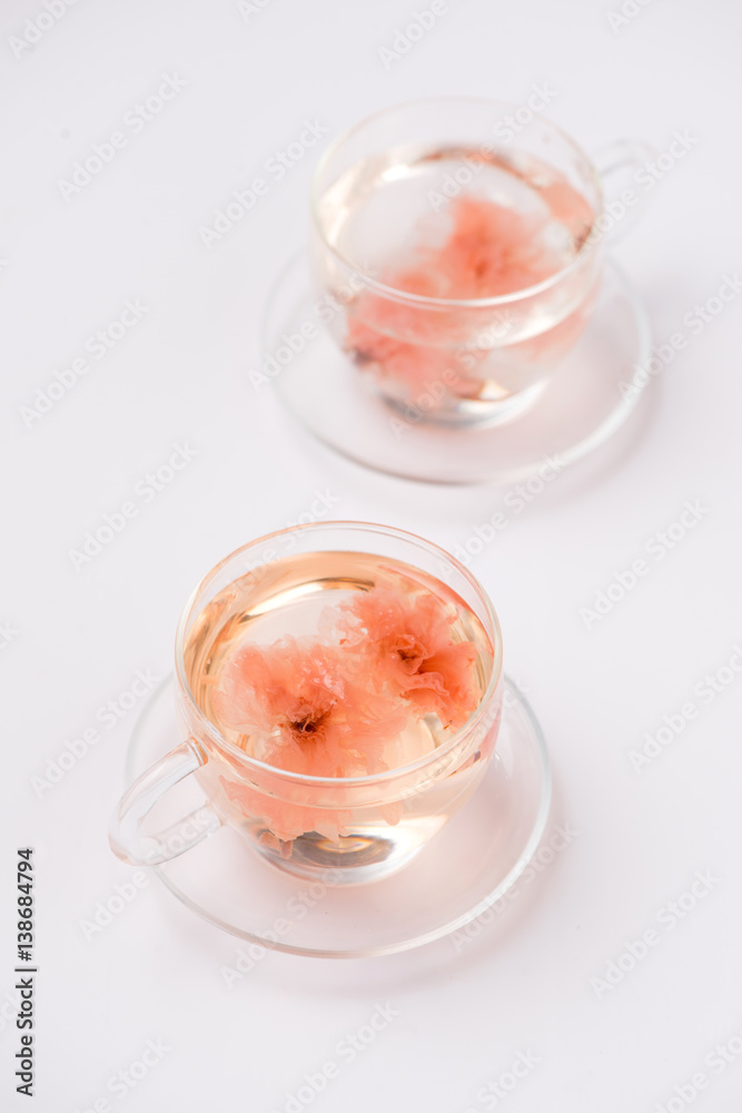 Cherry blossom (sakura) Japanese Herb tea on white background.