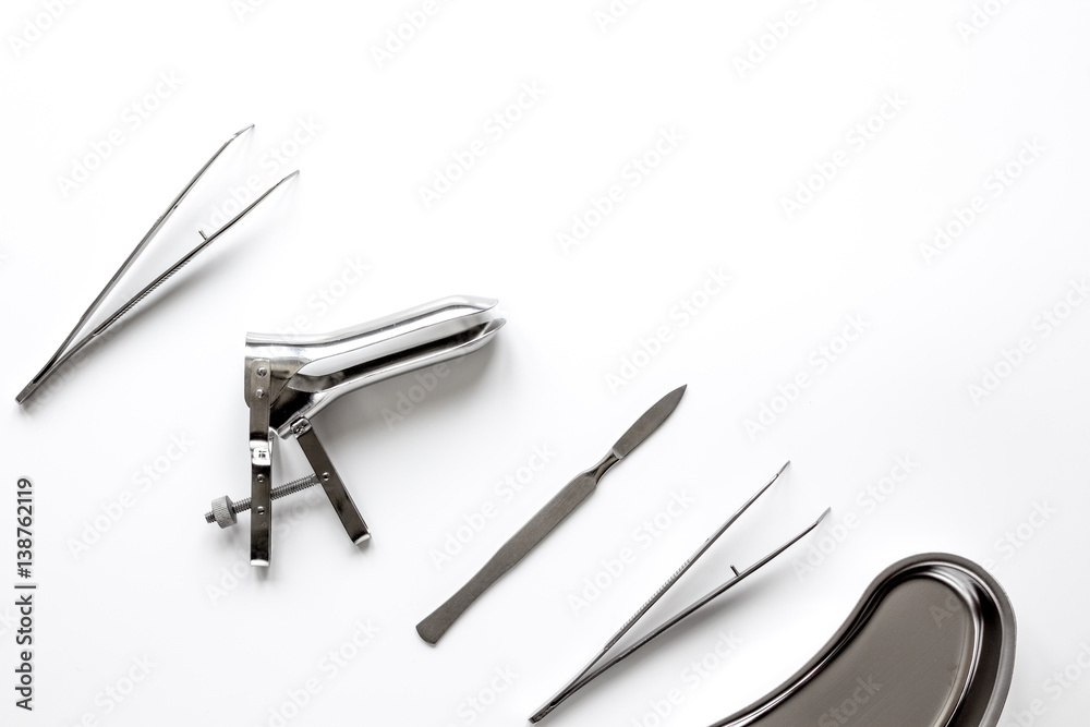 instruments of gynecologist on white background top view
