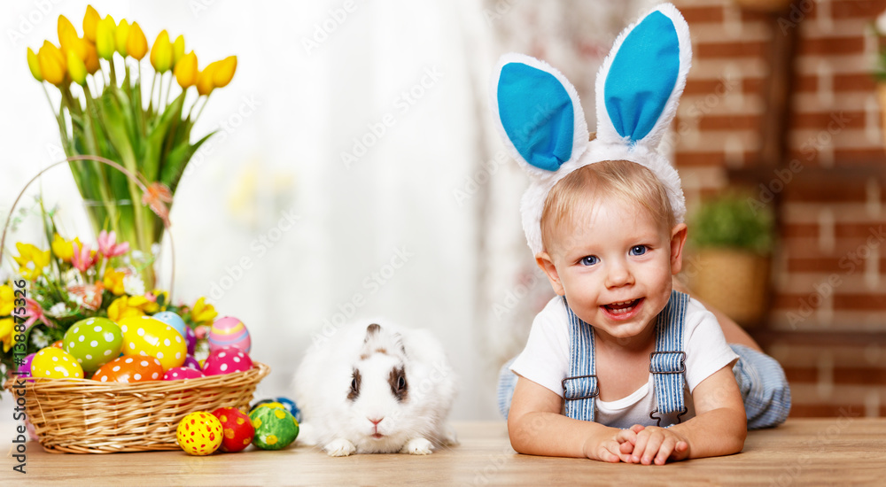 happy easter! happy funny baby boy playing with bunny