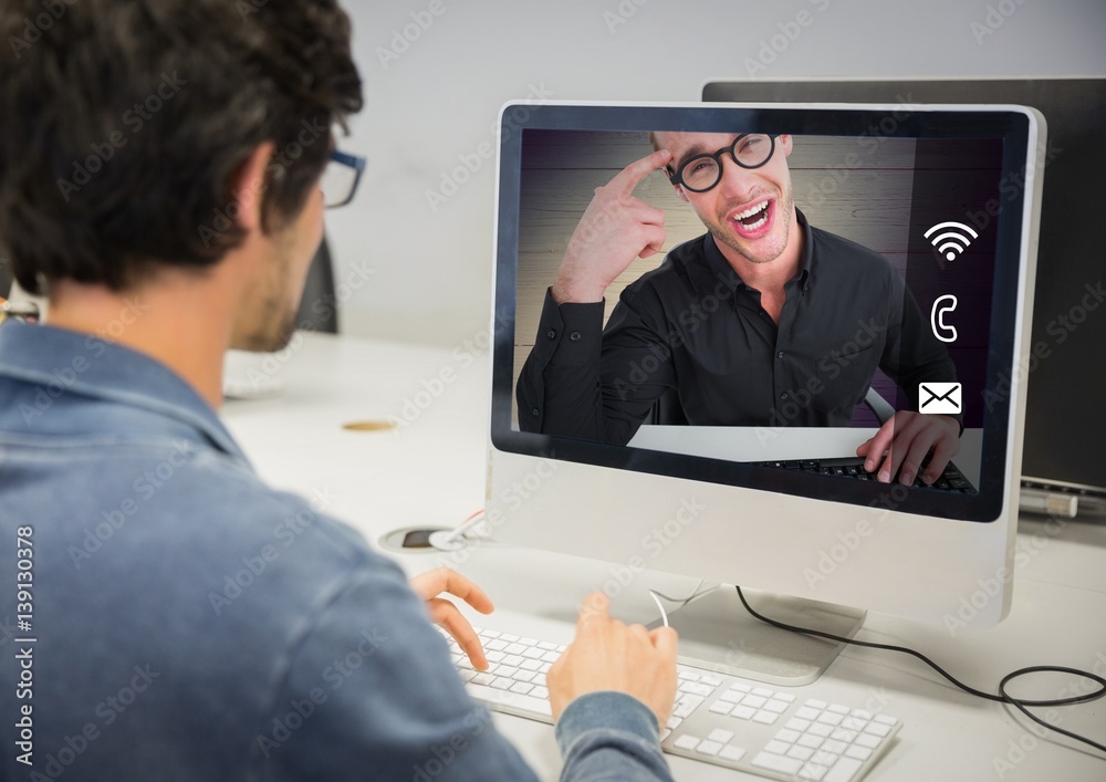 Man having a video call with his friend on desktop pc