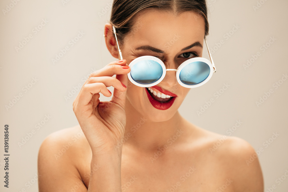 Beautiful woman winking with glasses