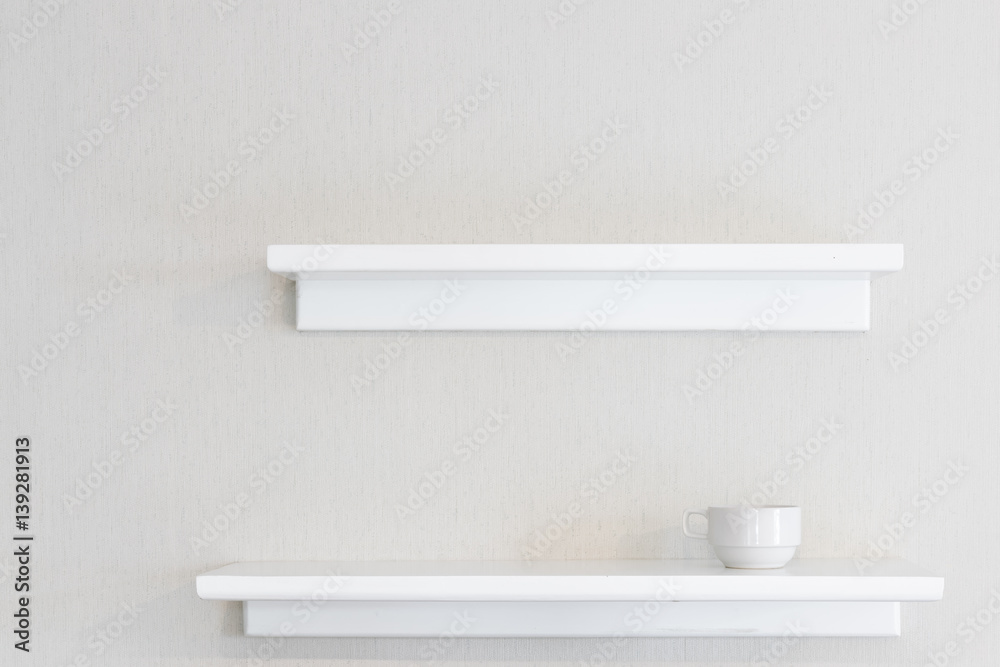 Empty white wood wall shelf and white concrete wall background