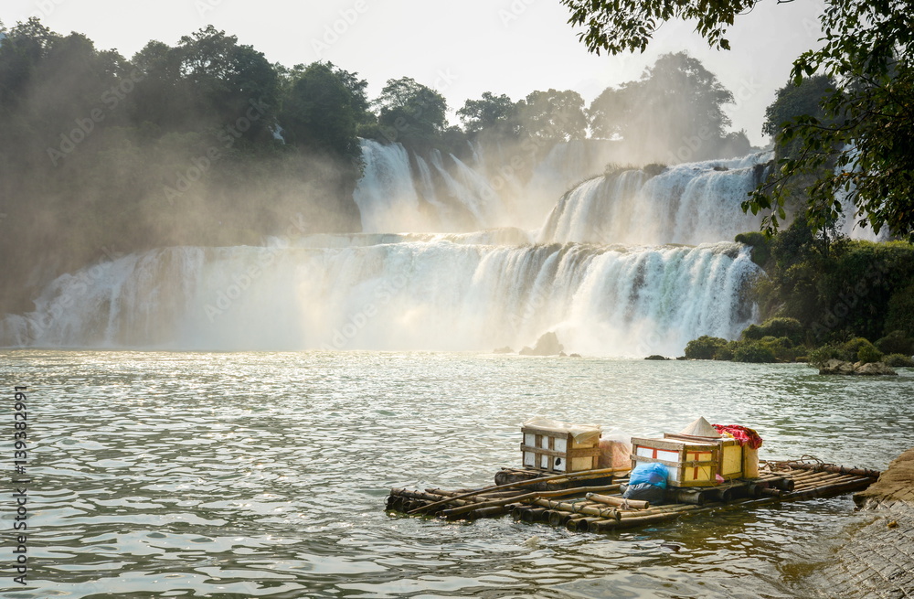 View at Detian waterfalls with bamboo raft on water
