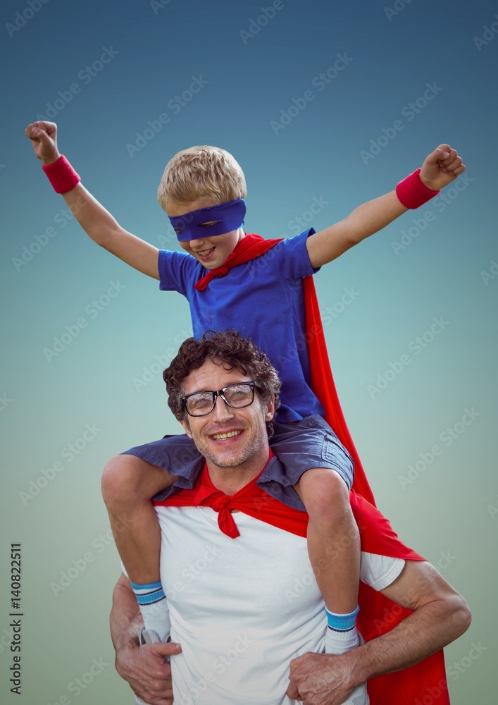 快乐的父亲和儿子穿着红色斗篷和面具玩得很开心