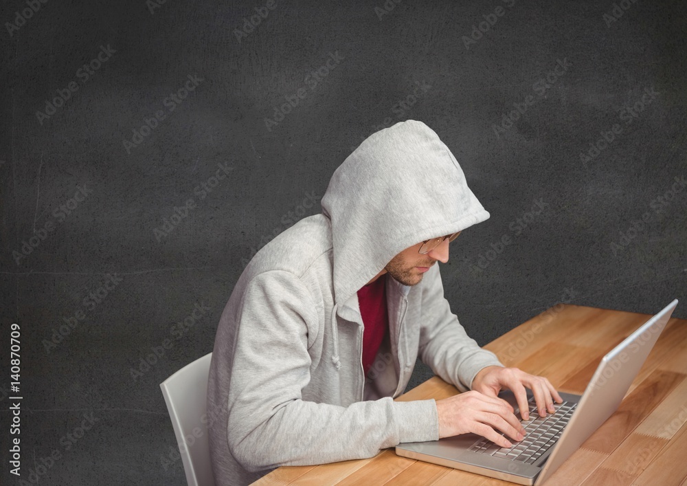 Man using laptop on wooden table