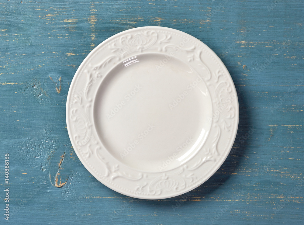 white plate on blue wooden table