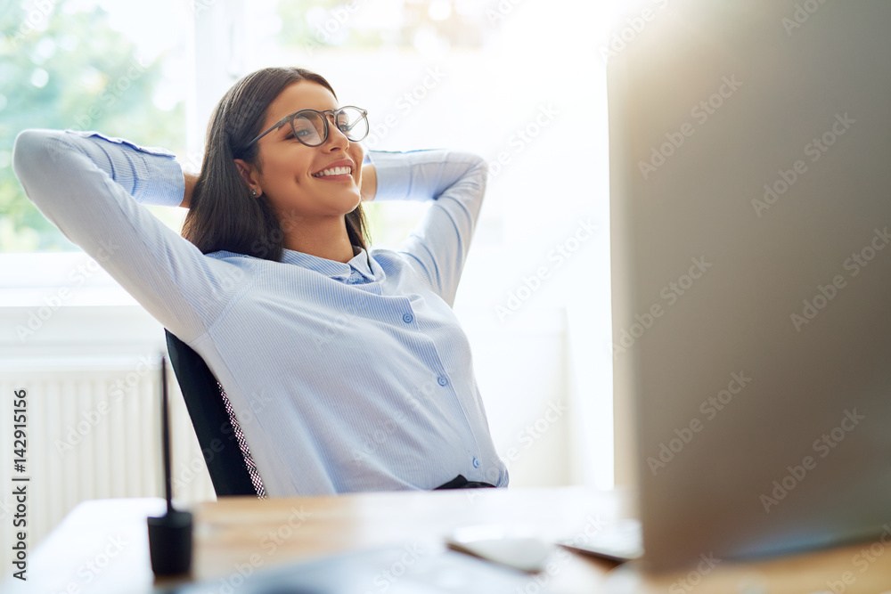 Woman with satisfied expression at desk