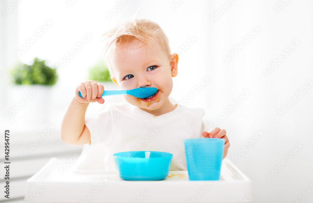 Happy baby eating himself