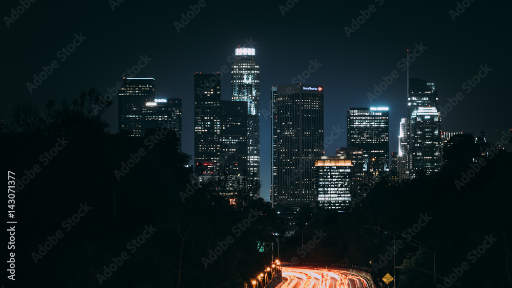Downtown Los Angeles at night view from highway leading to city