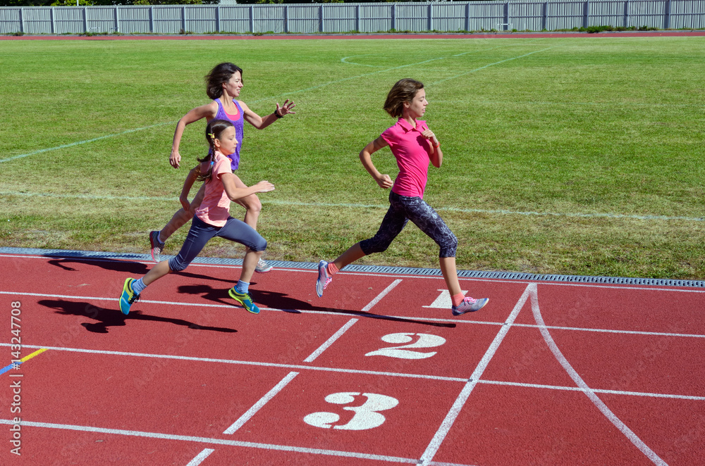 Family fitness, mother and kids running on stadium track, training and children sport healthy lifest