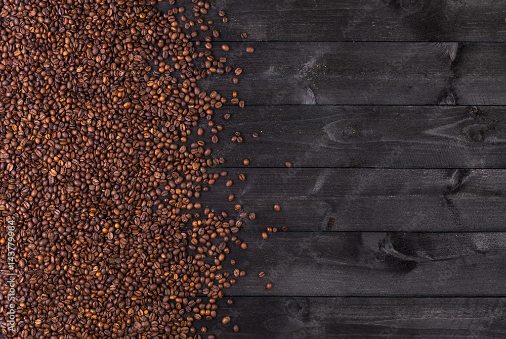 Coffee beans on dark wooden background. Top view with copy space