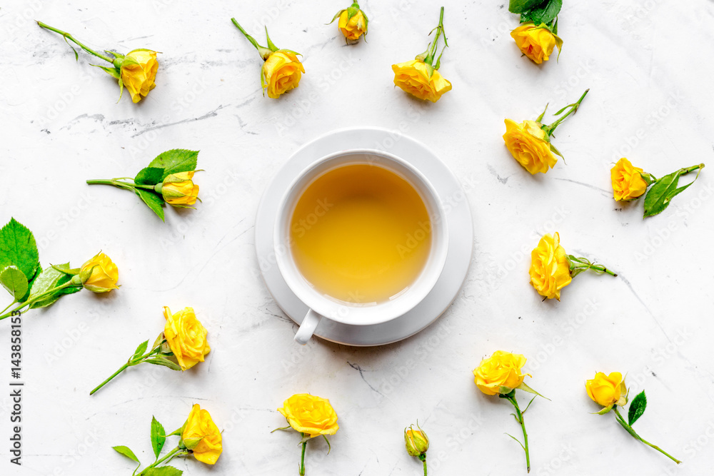 spring flatlay with flowers and cup of tea top view