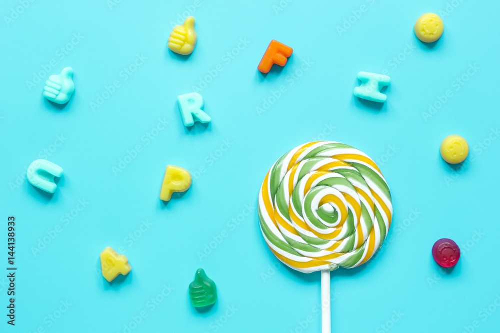 Delicious sugar lollipops on blue background top view pattern