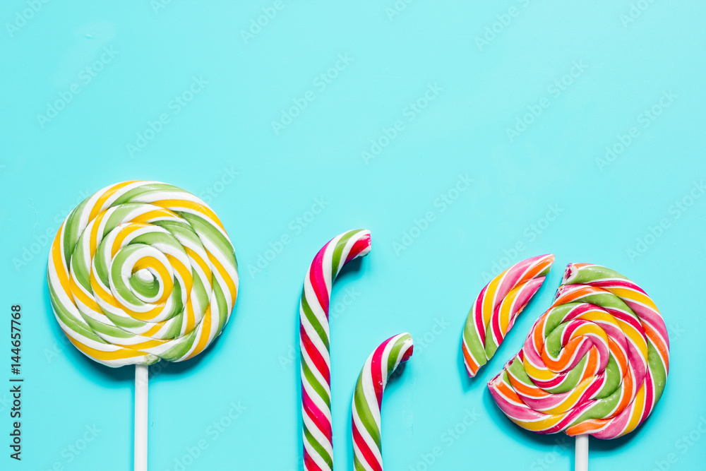 Colorful candies on blue texture background top view mock up