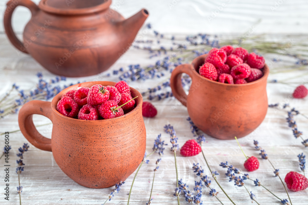 raspberry composition in pottery with dry lavender rustic background