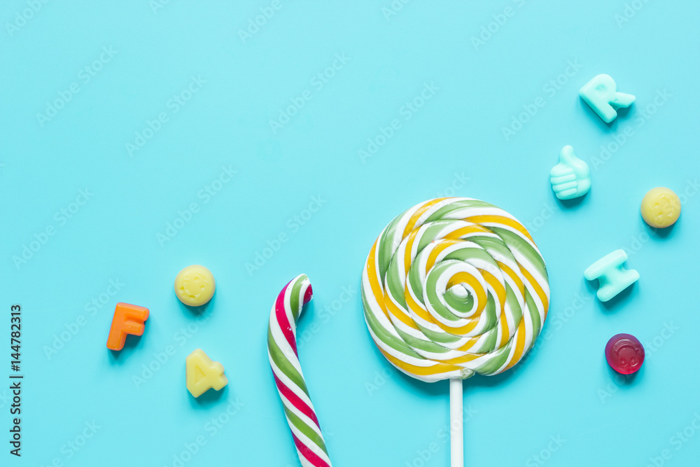 lollipop design with sugar candys on blue background top view mockup