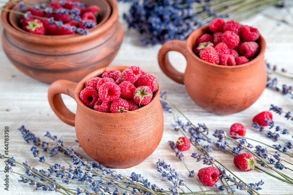 raspberry composition in pottery with dry lavender rustic background
