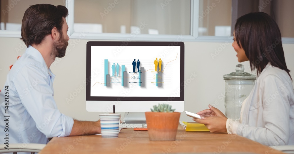 Side view of business people looking at graph on screen
