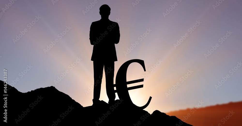 站在山丘上的欧元标志旁的侧影商人