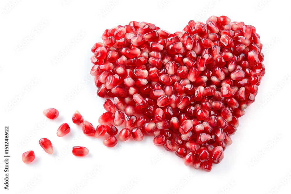 Pomegranate. Fresh raw seeds isolated on white background. Heart shape.