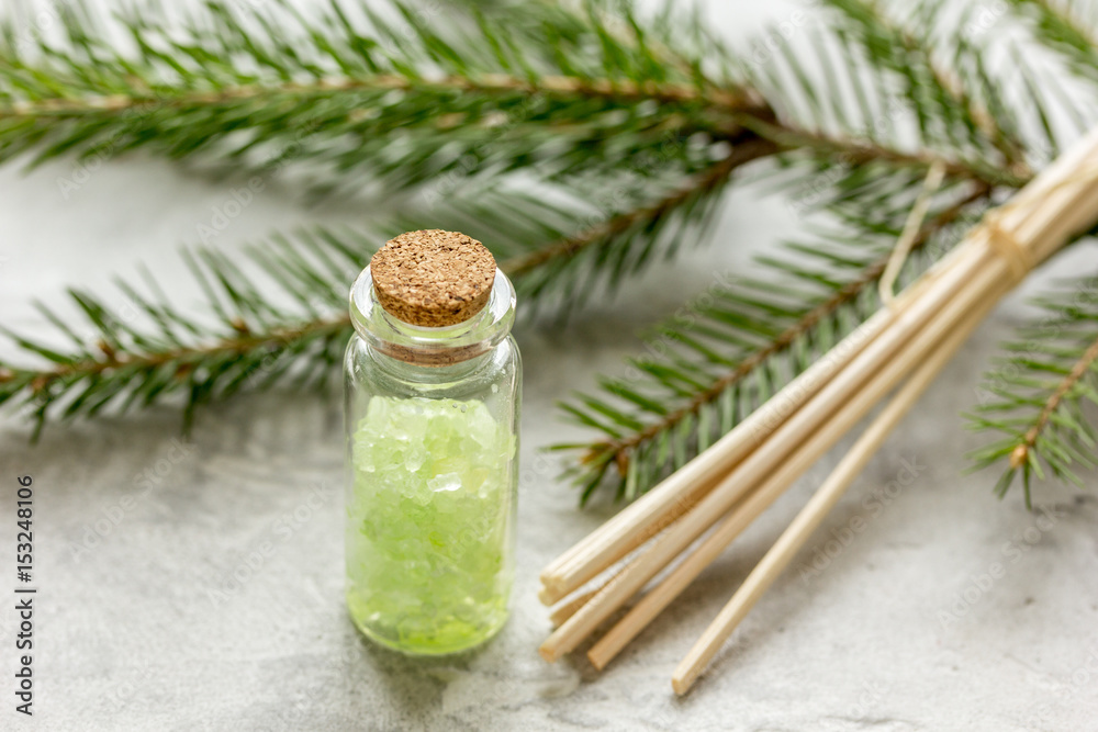 Spruce spa with organic salt in bottles on white table background