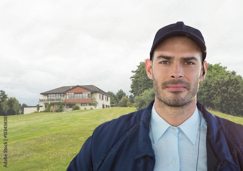 Portrait of security guard against house