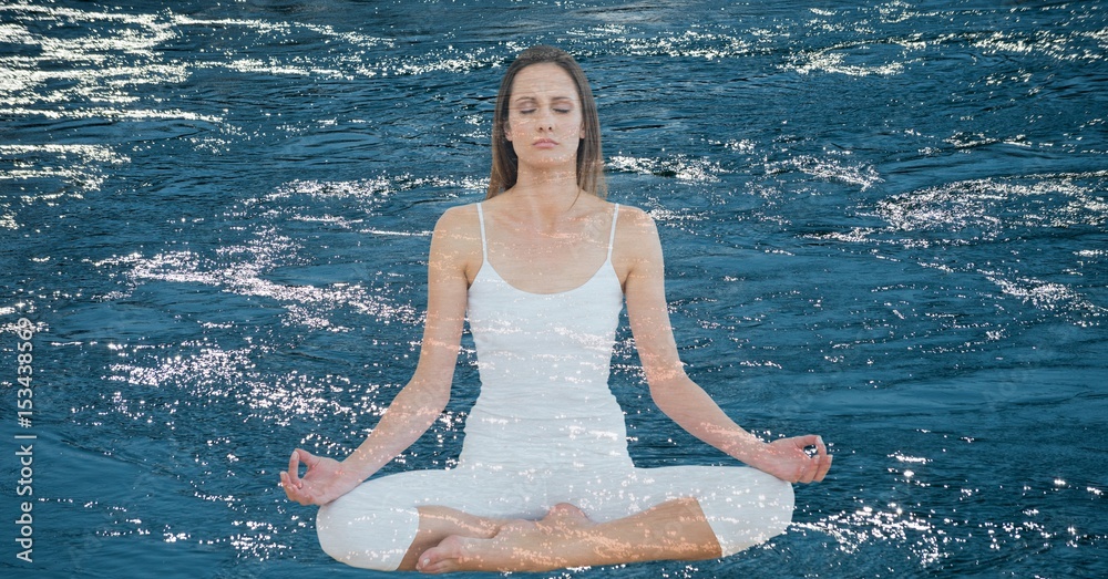 Double exposure of woman meditating over lake