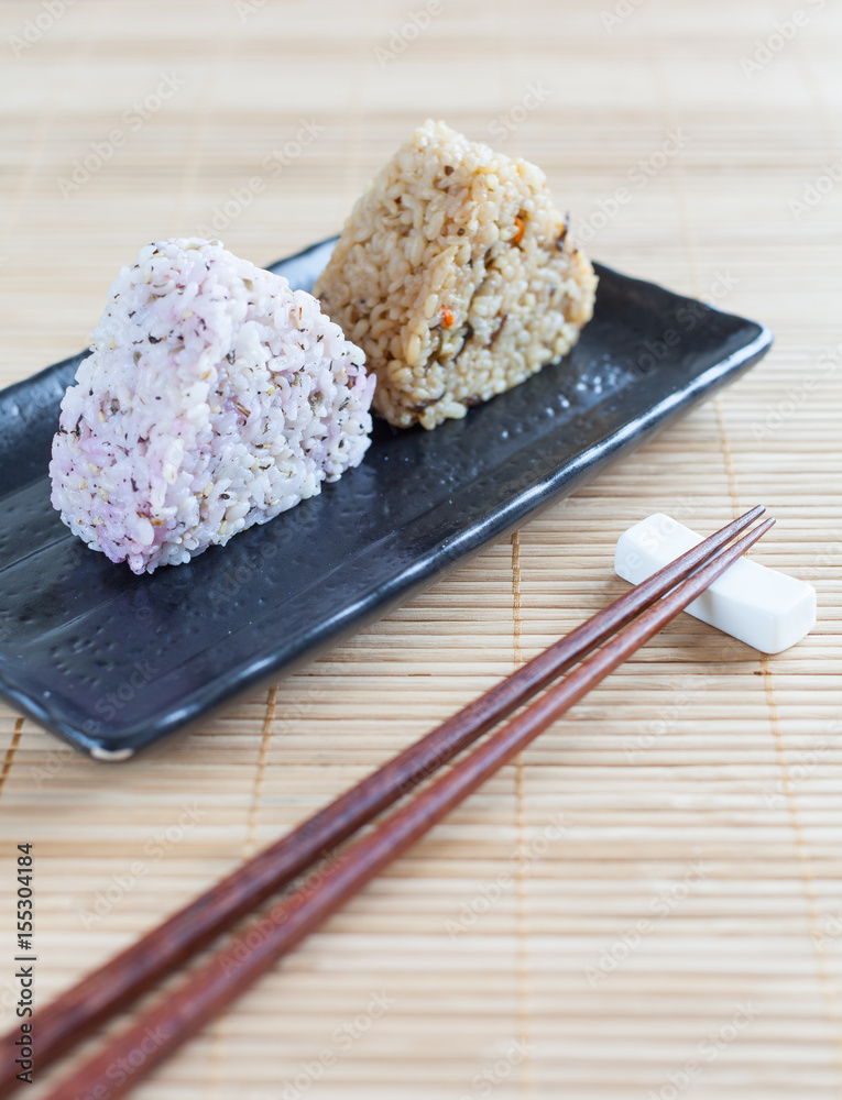 Onigiri , Japanese food rice ball made from white rice formed into triangular or cylindrical shapes.