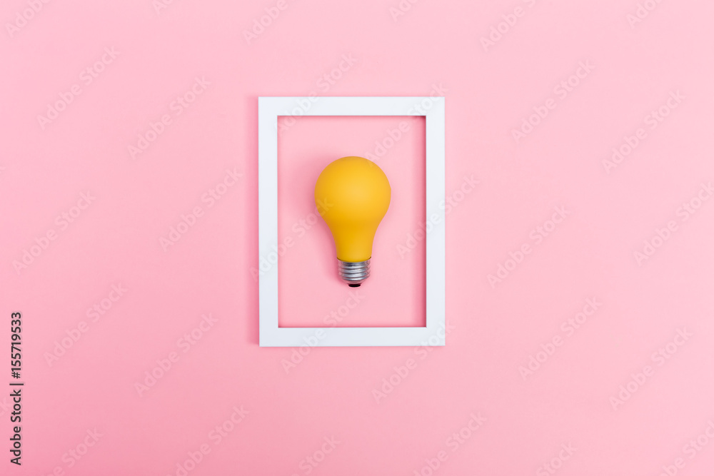 Colored lightbulb on a pink background