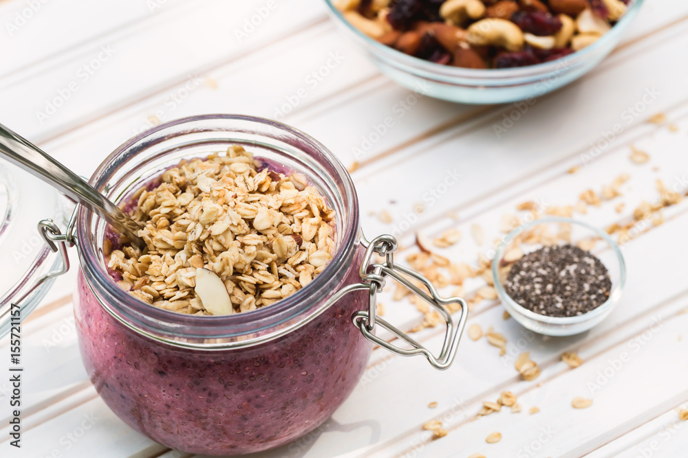 Smoothie topped with granola in a mason jar