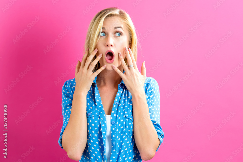 Surprised young woman posing