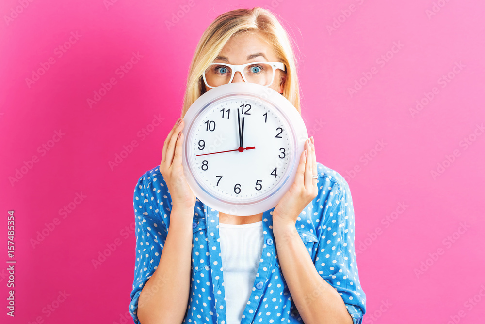  Woman holding clock showing nearly 12