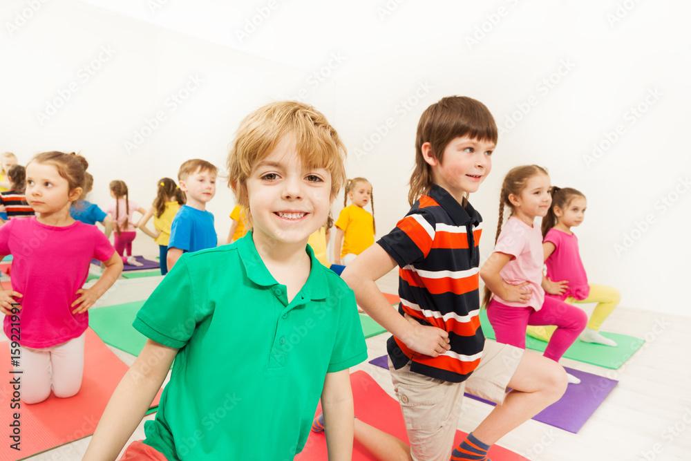Portrait of smiling blond kid boy at sports lesson