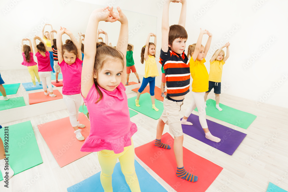Sporty kids stretching during gymnastic activity