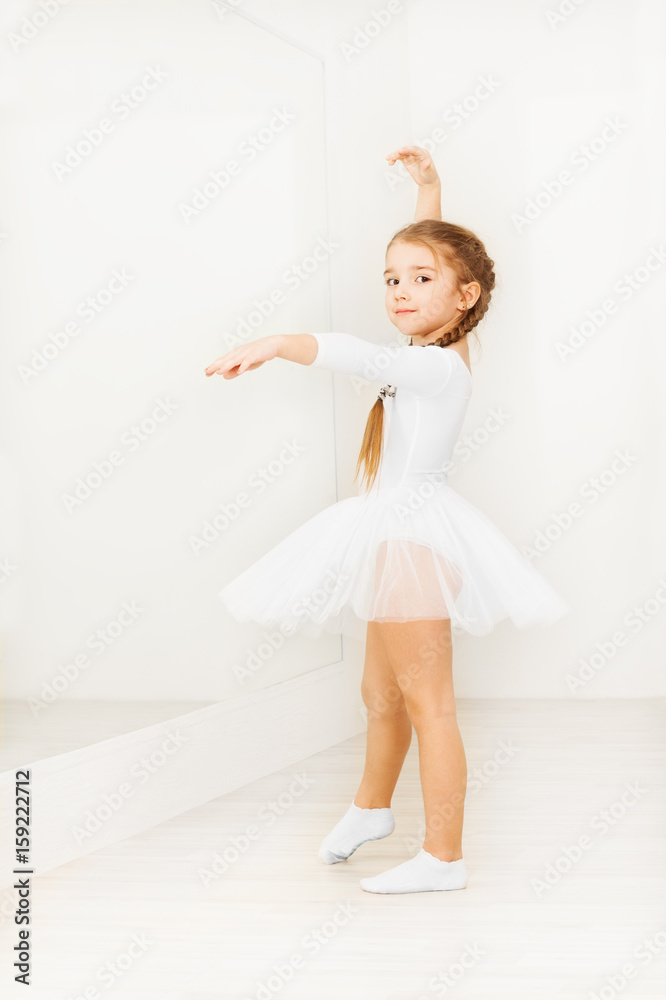 Little girl practicing posture during ballet class