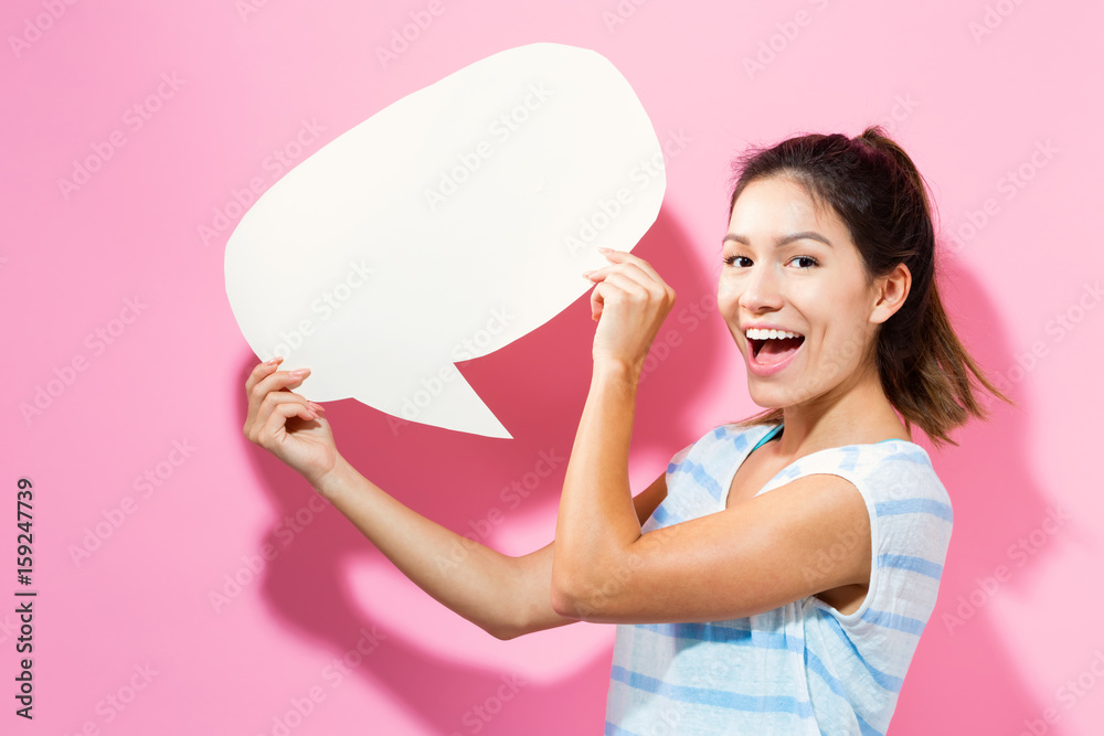 Young woman holding a speech bubble