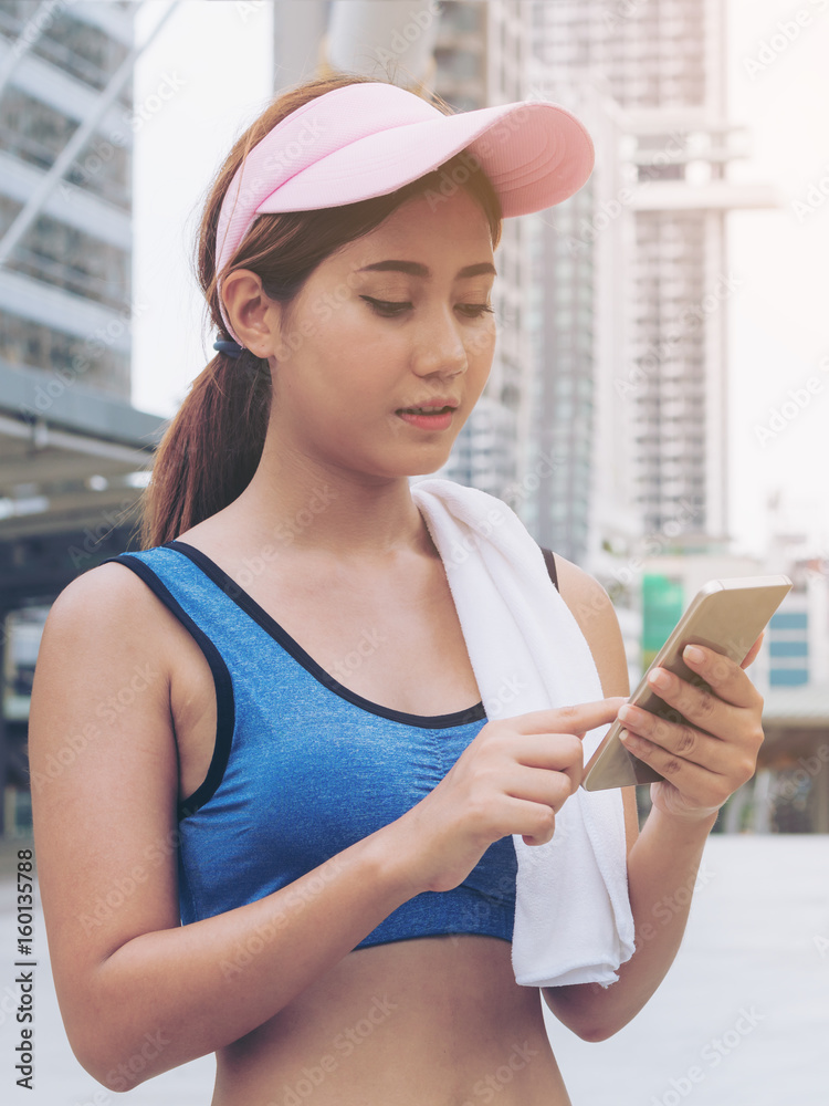 Sport woman runner using smartphone