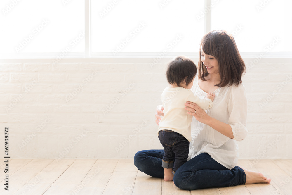 asian mother and child relaxing in living room