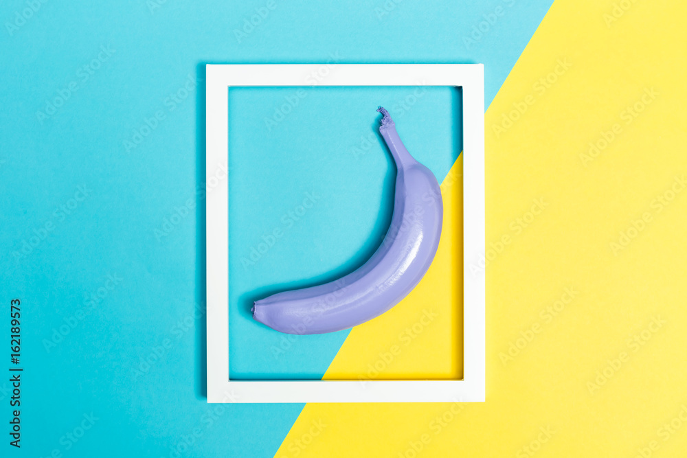 Painted banana on a vibrant background with a picture frame