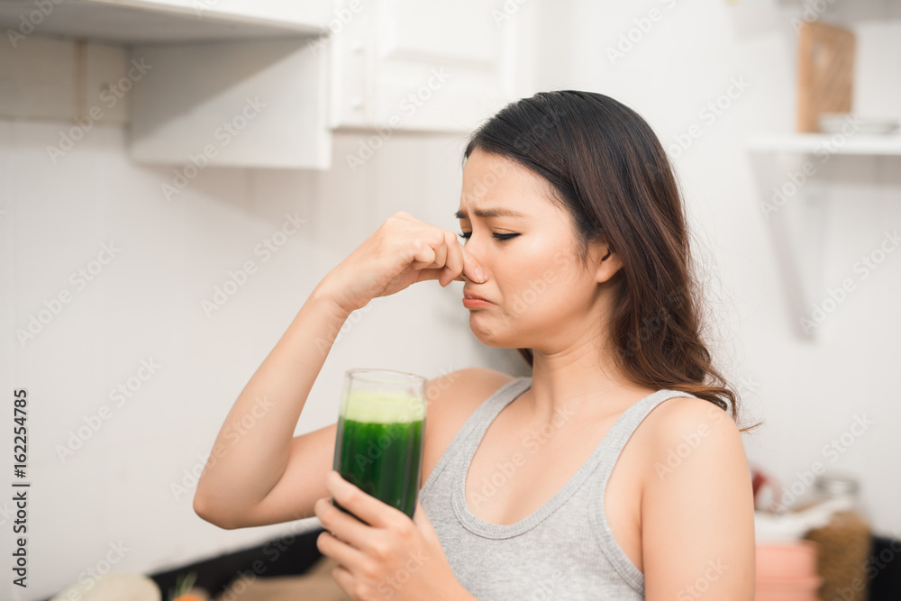 Young asian woman enjoy healthy vegetarian smoothie for weight loss and detox