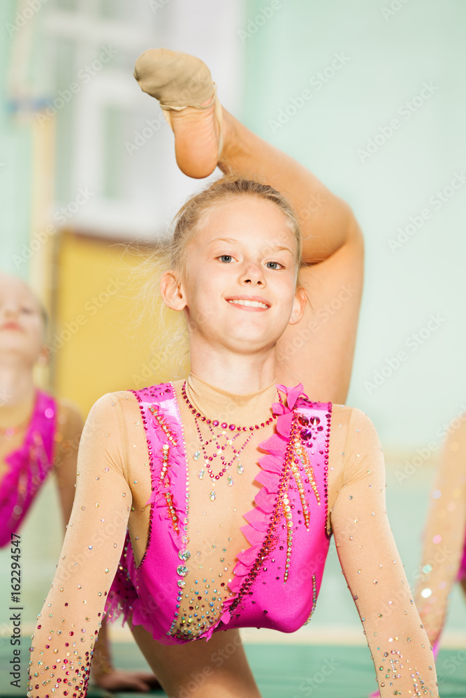 Portrait of happy girl doing rhythmic gymnastics
