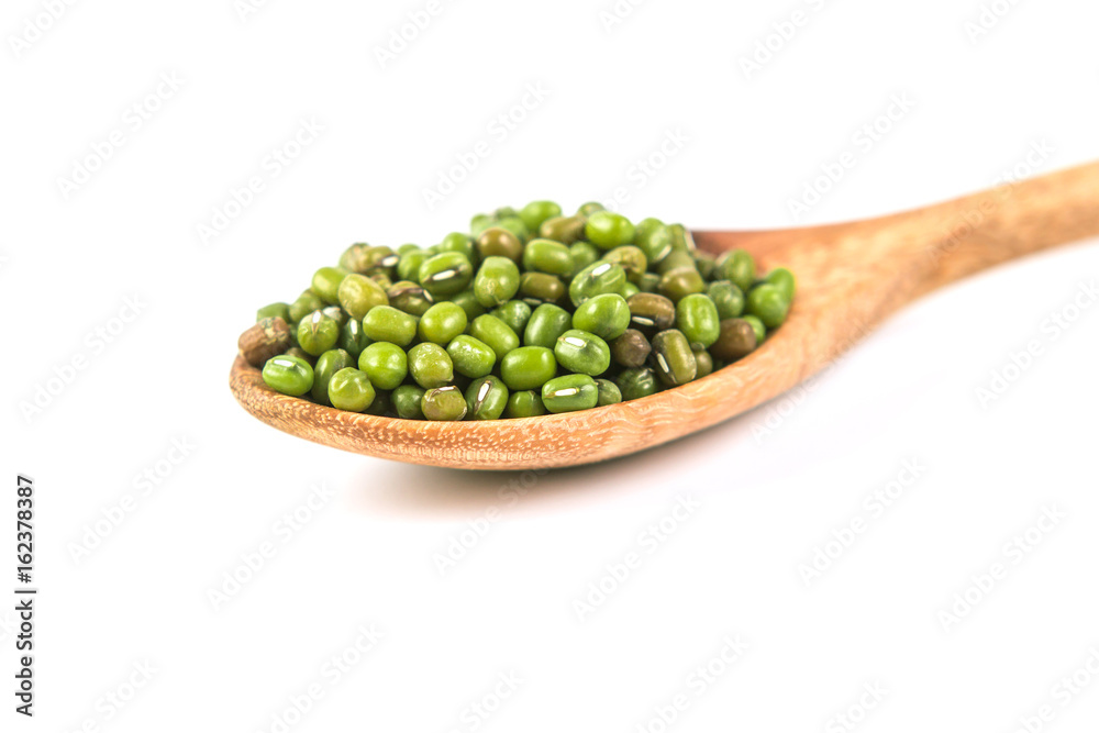 close up green mung beans in wooden spoon on white background