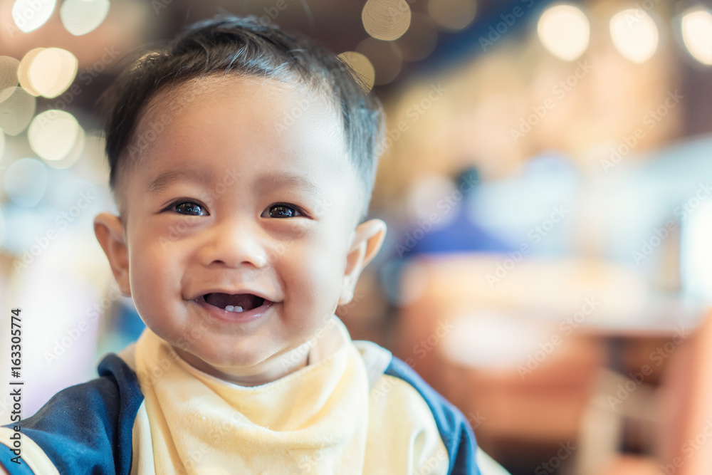 特写亚洲婴儿脸，微笑着9个月大。