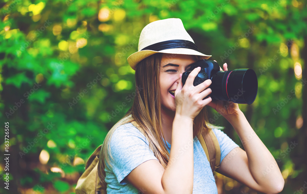 Female photographer in the forest with a camera